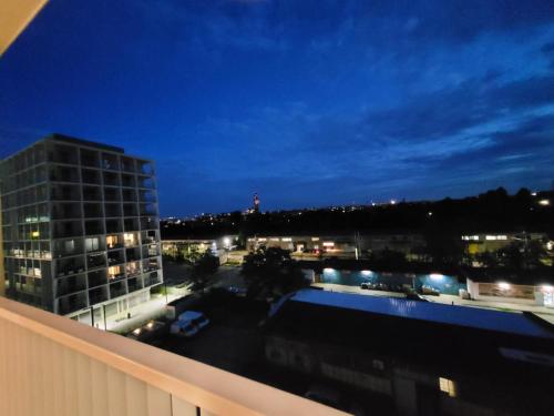 a view of a city at night from a building at Komfortowy apartament z balkonem i parkingiem in Wrocław