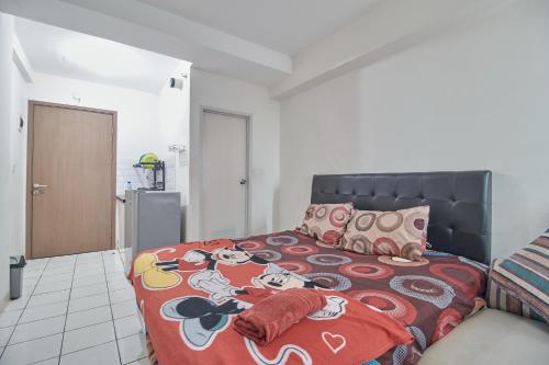 a bedroom with a bed with a mickey mouse blanket at Room Rendi Podomoro Golf View in Taladjurg-udik