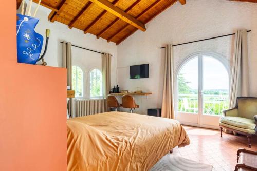 a bedroom with a bed and a large window at 1986MALAGAR in Baurech