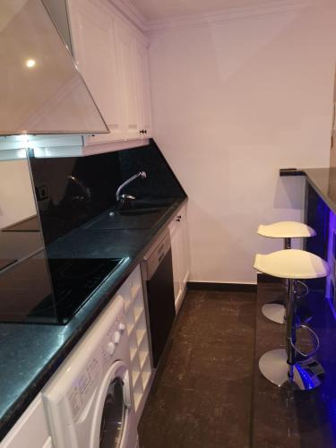 a kitchen with a stove and a sink and a dishwasher at Le Croisette center in Cannes
