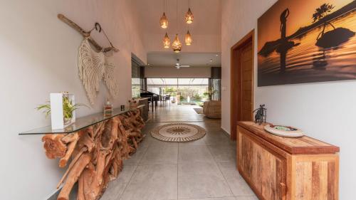 a lobby with a counter with logs on the wall at Villa Sartelo in Tamarin