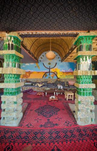 a room with a large room with a red carpet at Chez Madani in Mhamid