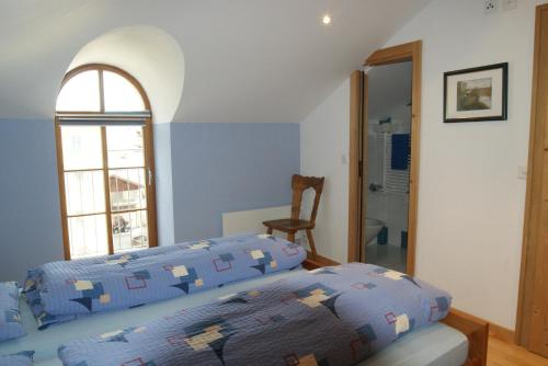 a bedroom with a bed and a window at Albergo Piz Cam in Vicosoprano