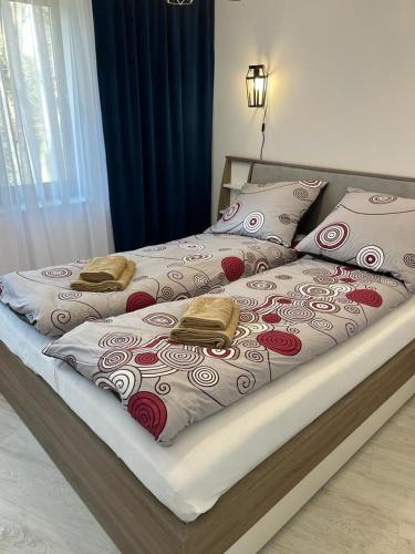 a bed with two pillows on top of it at Apartament Michaś in Szklarska Poręba