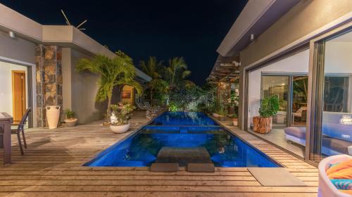 a swimming pool in the middle of a house at Villa Sartelo in Tamarin