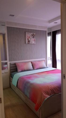 a bedroom with a large bed with a colorful blanket at The patio condo คอนโดวิวทะเล Floor 6 R75 in Ban Bang Saen (1)