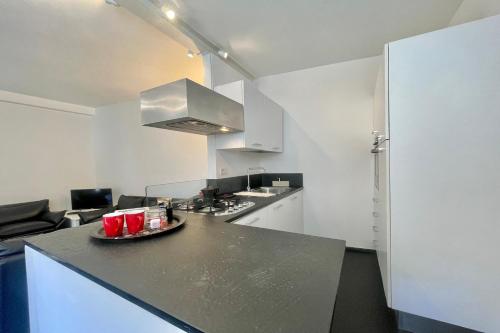 a kitchen with a black counter top in a room at Menaggio 57 in Menaggio