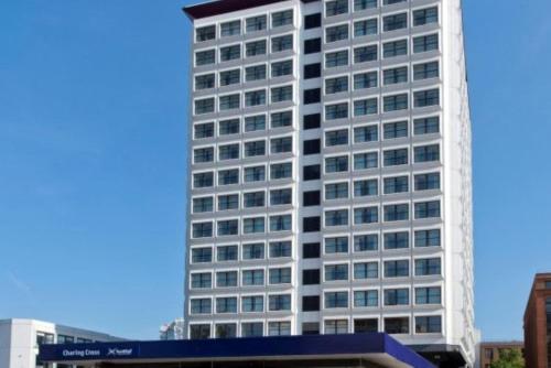 a tall white building with a lot of windows at Britannia Inn Glasgow in Glasgow