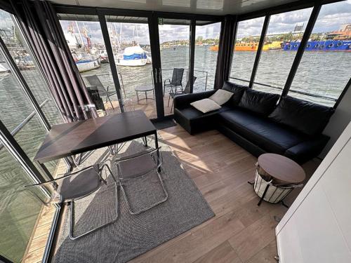 a living room with a couch and a table at GREBBESTAD - Hausboot im Herzen von Göteborg in Gothenburg