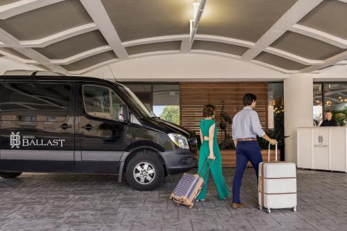 a man and a woman standing in front of a van at Hotel Ballast Wilmington, Tapestry Collection by Hilton in Wilmington