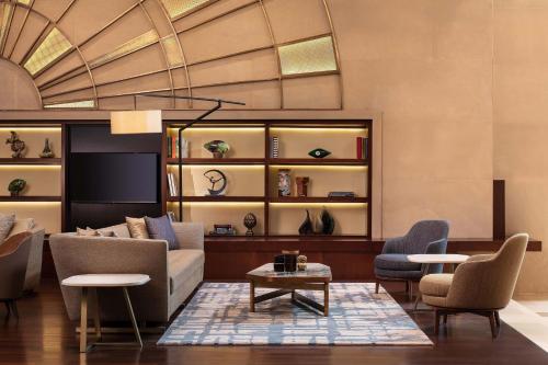 a living room with a couch and chairs and a table at Sheraton Istanbul Levent in Istanbul