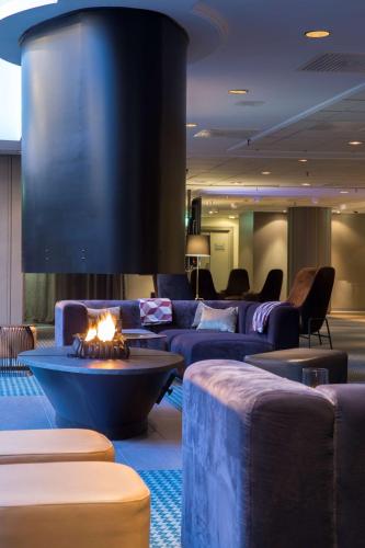 a living room with couches and a fire place at Radisson Blu Hotel Bodø in Bodø