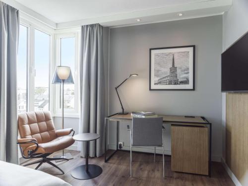 a hotel room with a desk and a chair at Radisson Blu Hotel Bodø in Bodø