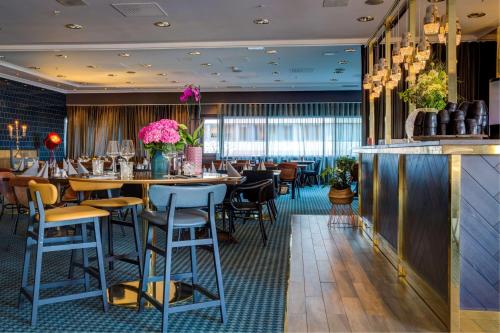 a restaurant with tables and chairs and a bar at Radisson Blu Hotel Bodø in Bodø