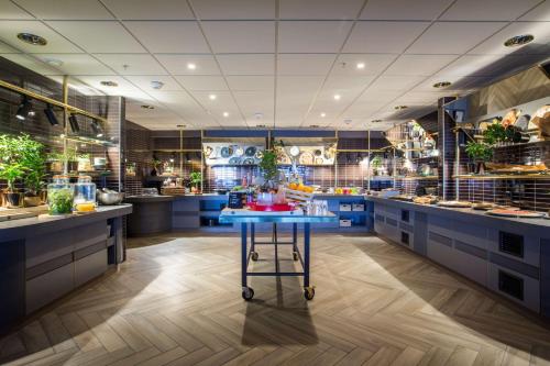 a large kitchen with blue cabinets and a blue table at Radisson Blu Hotel Bodø in Bodø