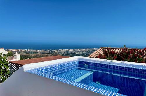 a swimming pool on the roof of a house at Casa Sierra - Mijas Pueblo in Mijas