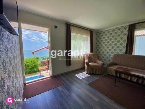a living room with a view of the ocean at BLUE DIAMOND SEVAN in Sevan