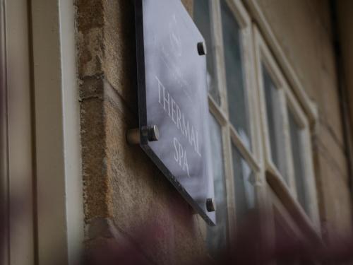 a street sign on the side of a building at Hazlewood Castle & Spa in Tadcaster