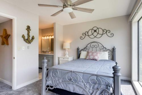 a bedroom with a bed and a ceiling fan at Community Pool Lakefront Osage Beach Condo! in Osage Beach