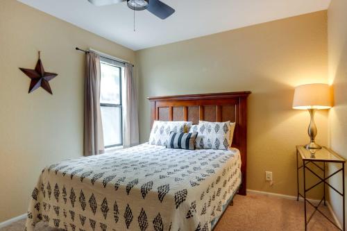 a bedroom with a bed and a window at Community Pool Lakefront Osage Beach Condo! in Osage Beach