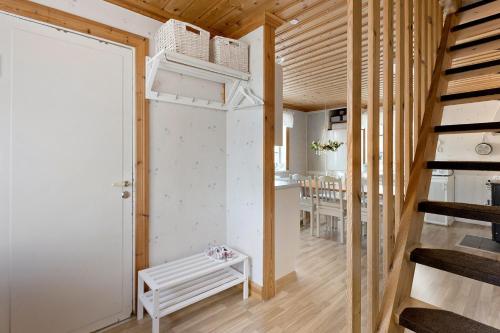 a tiny house with a staircase and a white bench at Prästänge in Vallsta