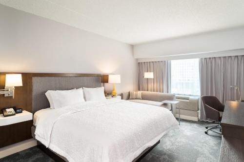 a hotel room with a large bed and a desk at Hampton Inn Philadelphia Center City-Convention Center in Philadelphia