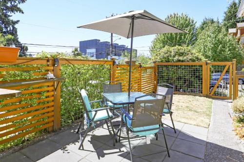 a table and chairs with an umbrella on a patio at Scandi Boho Seattle Apartment, Walk to Waterfront! in Seattle