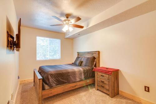 a bedroom with a bed and a ceiling fan at Duck Creek Village Cabin with Fire Pit and Grill! in Duck Creek Village