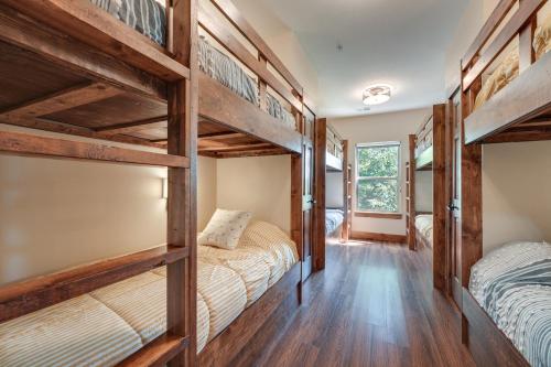 two bunk beds in a room with wooden floors at Luxe Table Rock Lake Vacation Rental with Hot Tub! in Lampe