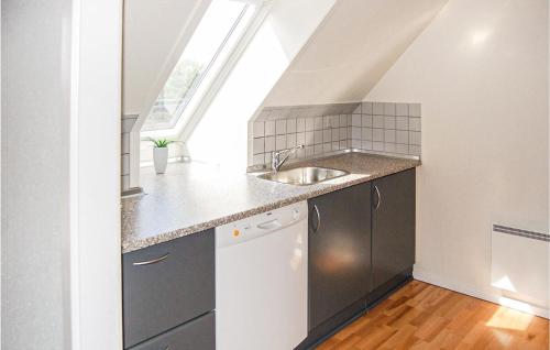 a small kitchen with a sink and a window at Gorgeous Apartment In Blvand With Wifi in Blåvand