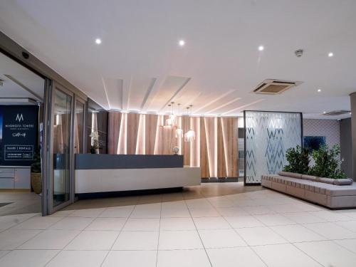 a lobby with a reception desk in a building at Masingita Towers Hotel and SPA in Johannesburg
