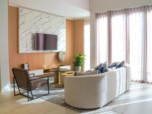 a living room with a couch and a table at Masingita Towers Hotel and SPA in Johannesburg