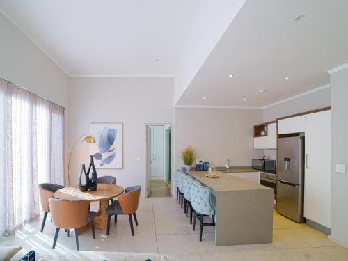 a kitchen and dining room with a table and chairs at Masingita Towers Hotel and SPA in Johannesburg