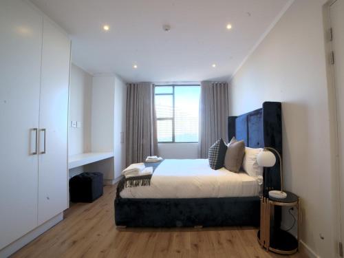 a bedroom with a bed and a large window at Masingita Towers Hotel and SPA in Johannesburg