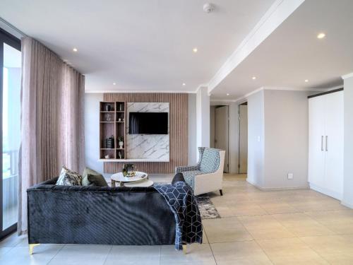 a living room with a couch and a table at Masingita Towers Hotel and SPA in Johannesburg