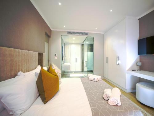 a bedroom with a large bed with towels on it at Masingita Towers Hotel and SPA in Johannesburg
