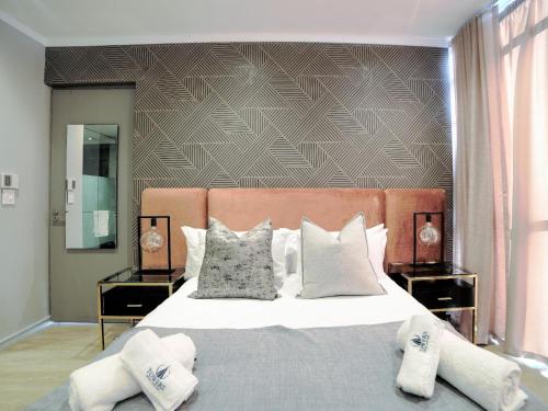 a bedroom with a large bed with two night stands at Masingita Towers Hotel and SPA in Johannesburg