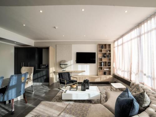 a living room with a couch and a table at Masingita Towers Hotel and SPA in Johannesburg