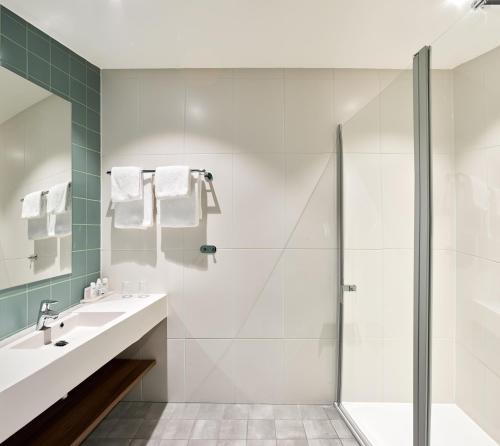 a bathroom with a shower and a sink at Park Inn By Radisson Hasselt in Hasselt