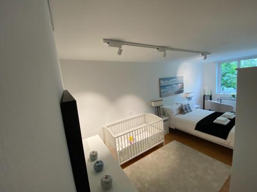 a bedroom with a bed and a crib in it at Casa Bella in Weinheim