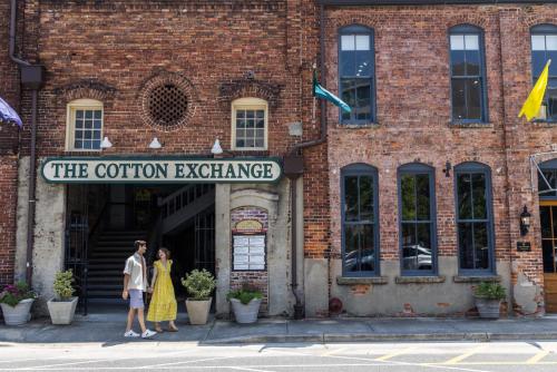 two people standing in front of a brick building at Hotel Ballast Wilmington, Tapestry Collection by Hilton in Wilmington