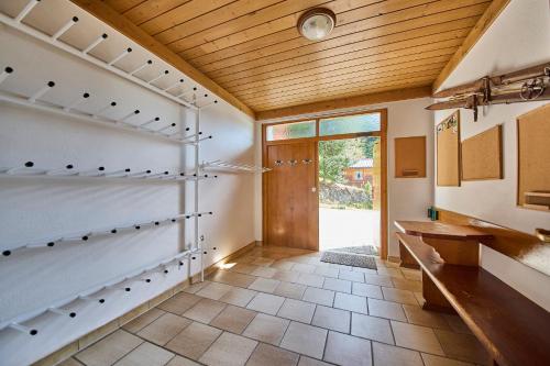 a room with a hallway with a wooden ceiling at Landhaus Eichenhof in Saalbach Hinterglemm