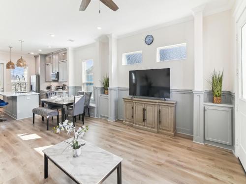 a kitchen and living room with a flat screen tv at Sandy Smiles in Galveston