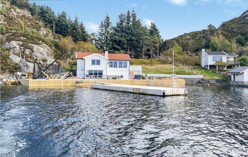 a house on a dock on a body of water at Stunning Home In Fitjar With Wifi in Fitjar