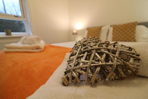 a bedroom with a bed with a sculpture on it at Signature - Carrick View in Cumbernauld