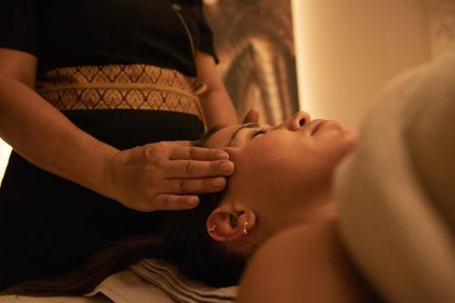 a woman is getting her hair done in a salon at Luxury Rooms Skadarlija in Belgrade