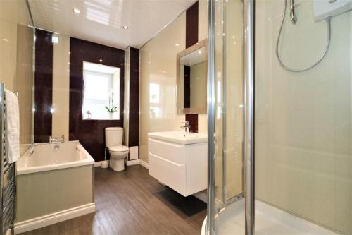 a bathroom with a sink and a shower at Signature - Kirkhill House in Kirkmuirhill