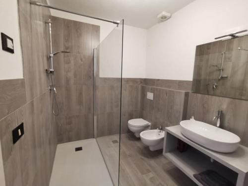 a bathroom with a shower and a sink and a toilet at Appartamento di design sull'Altopiano di Asiago in Tresché Conca