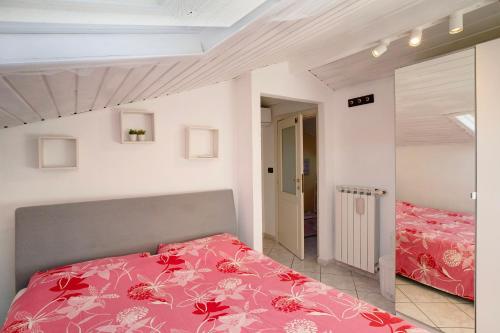 a bedroom with two beds with red comforter at Ca' a riga in Diano Castello