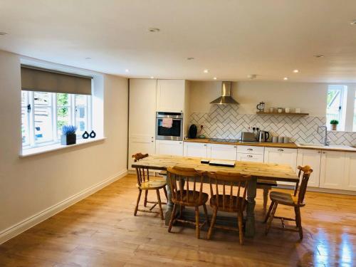 a kitchen with a large wooden table and chairs at The Cottage 